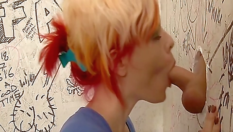 Busty blonde trans slut fucks her partner in the glory hole